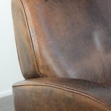 Set of two vintage sheepskin leather design armchairs in a cognac colour
