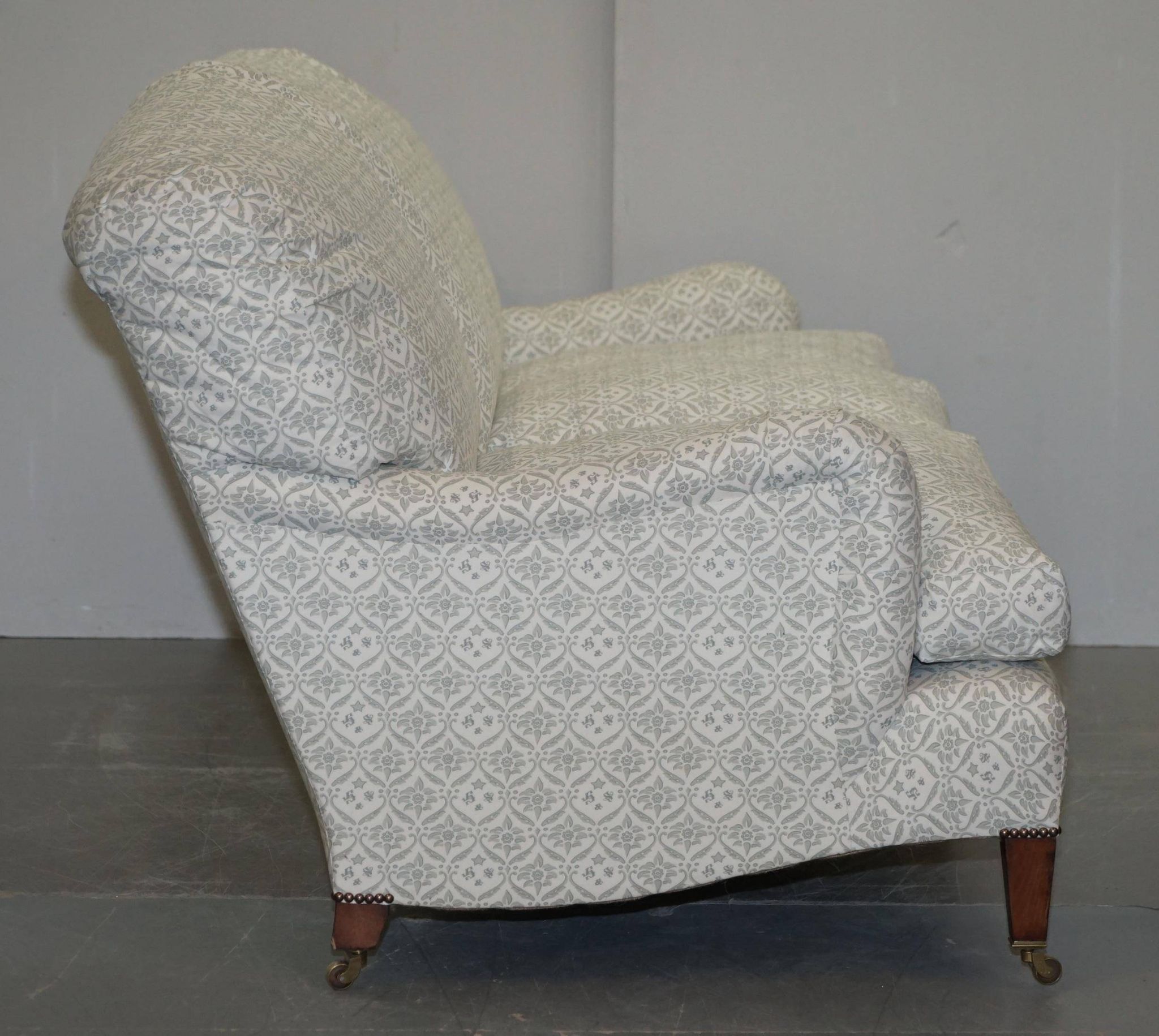 Howard & Sons canapé with feather cushions and ticking fabric, Victorian style.