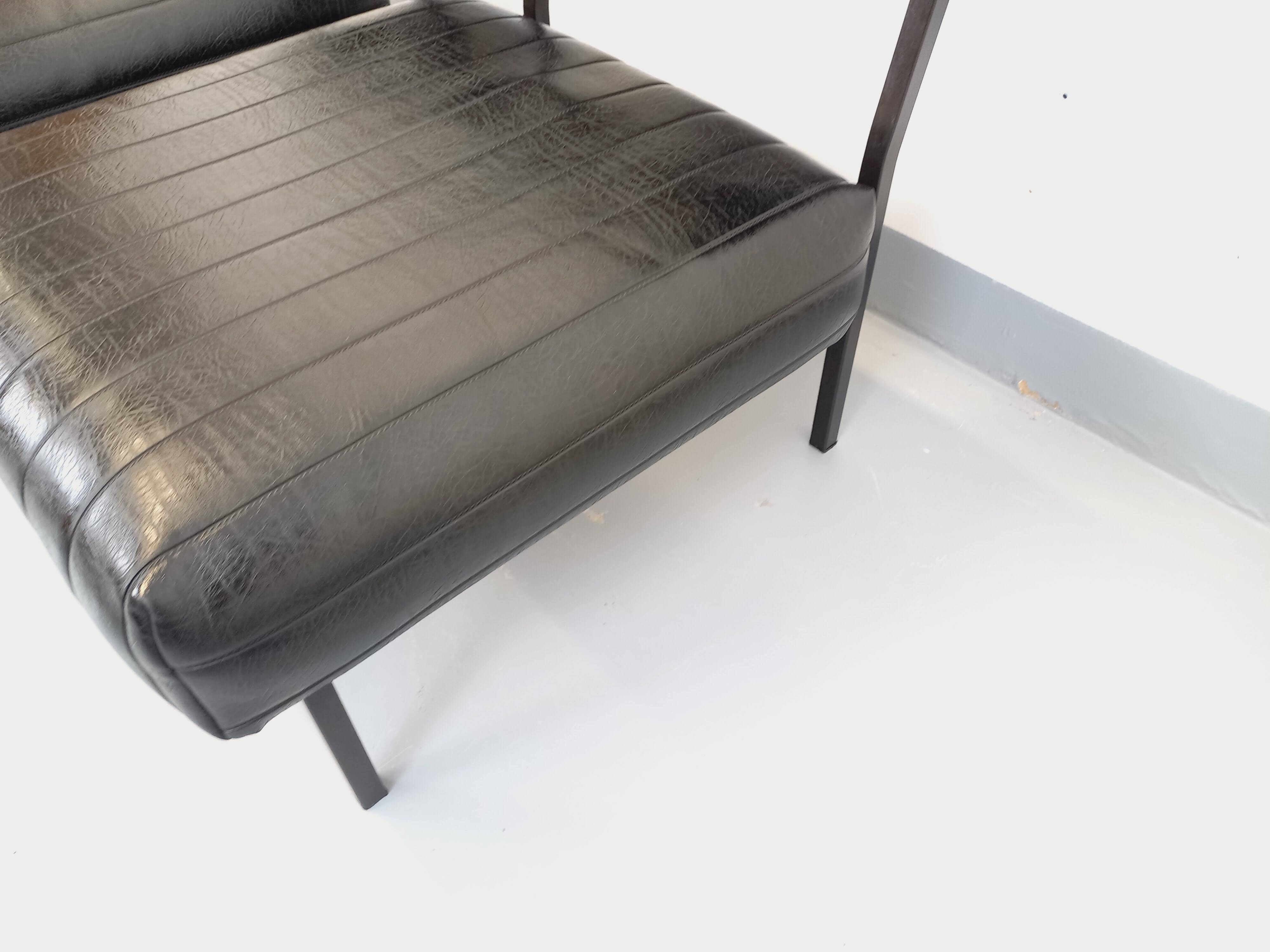 Set of 2 vintage modernist armchairs in black faux leather and metal.
