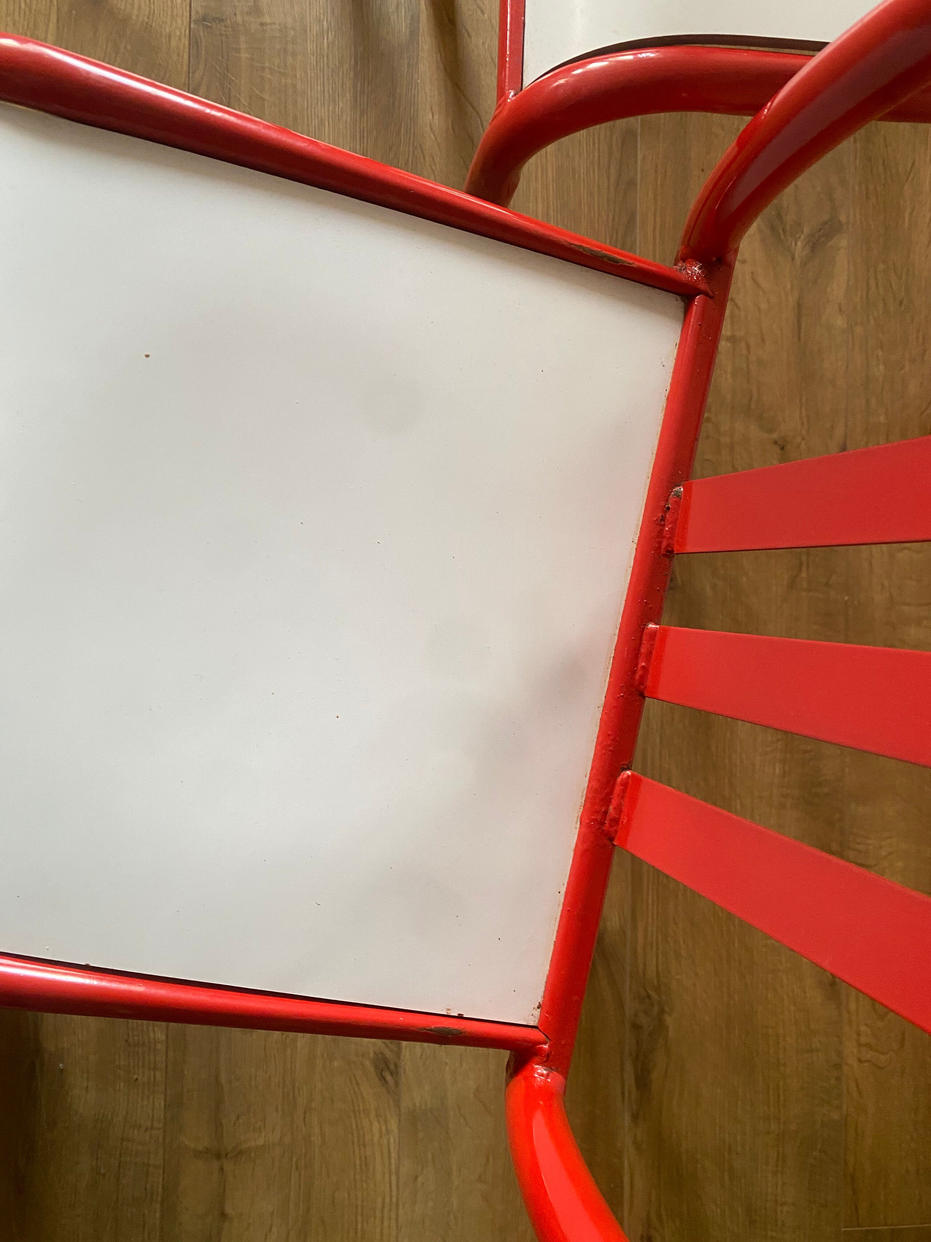 4 red metal chairs by Mallet-Stevens