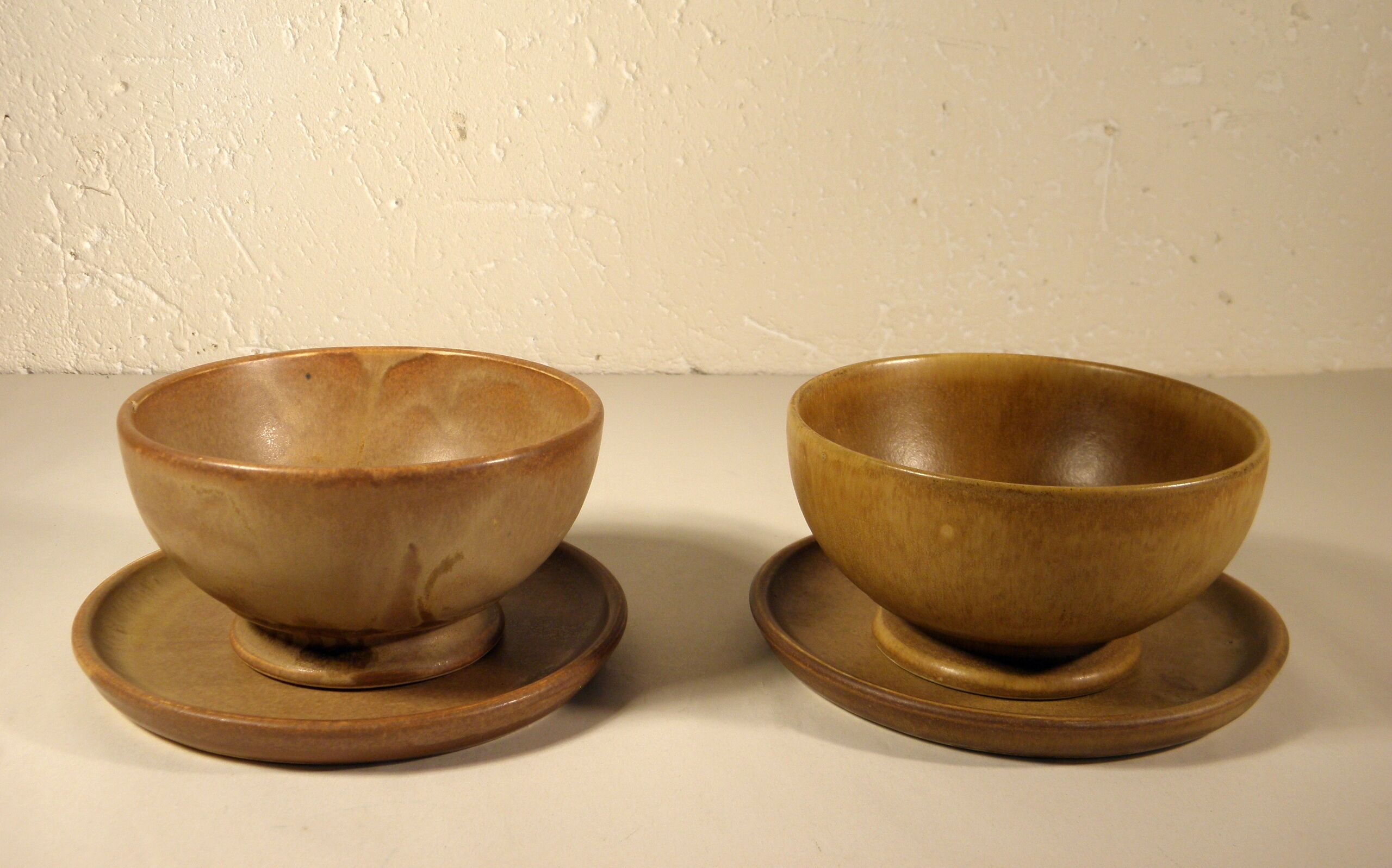 Two sandstone bowls and saucers