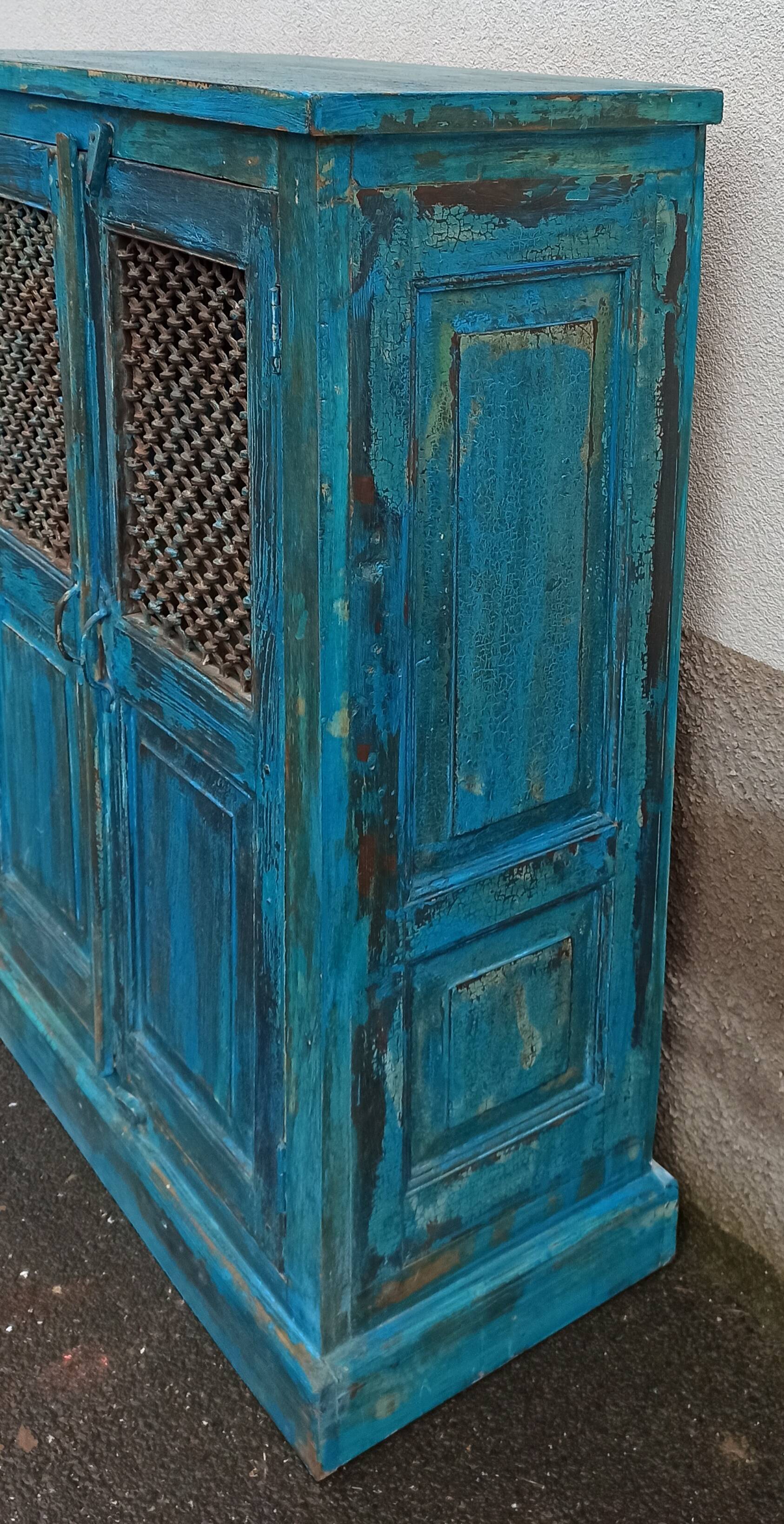 Old wooden cabinet with doors with grille