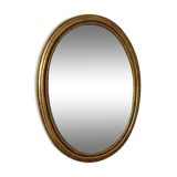 Oval mirror in antique gilded wood