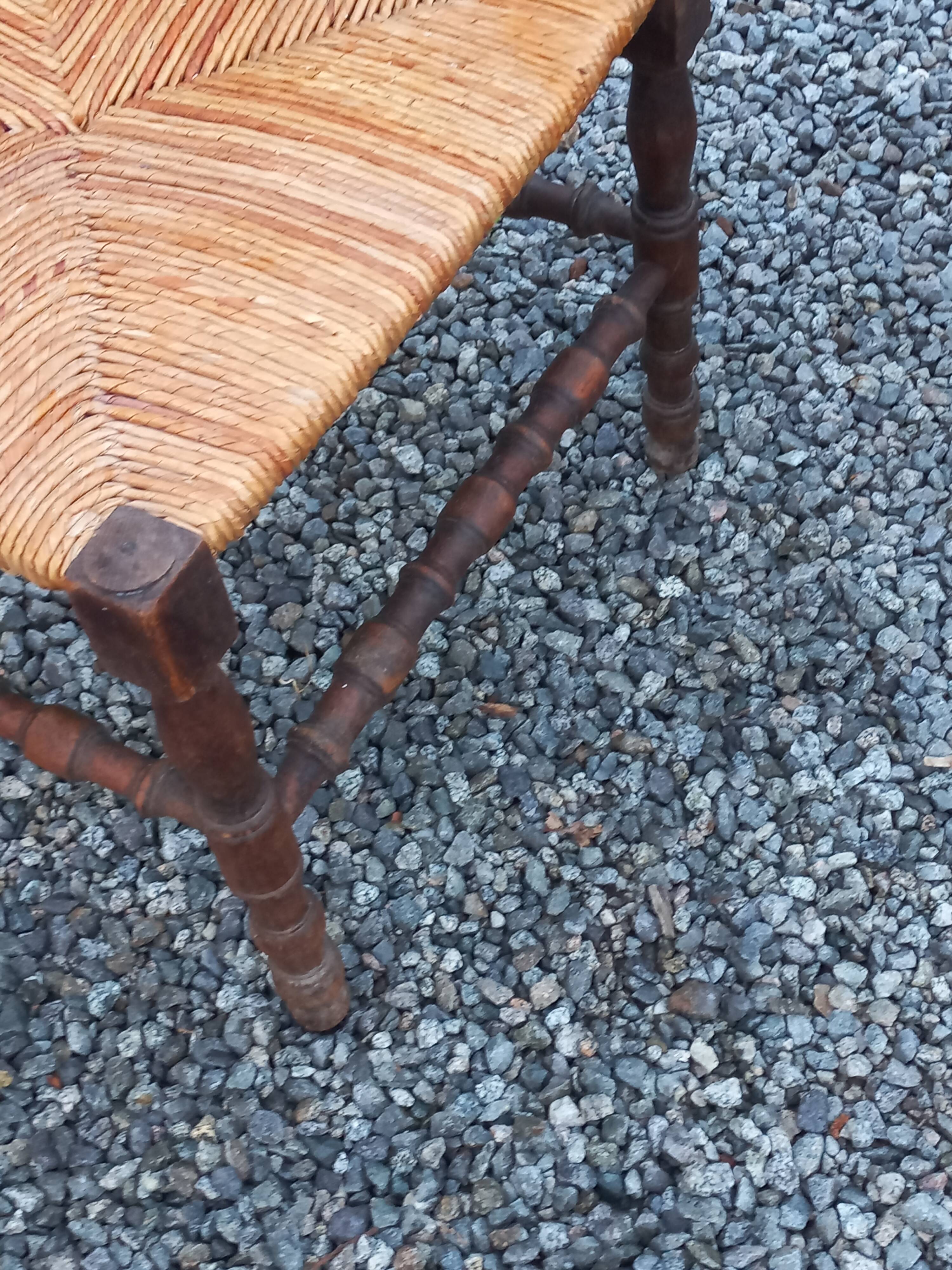 Pair of angled armchairs with turned wood and rush seats from the 1960s.