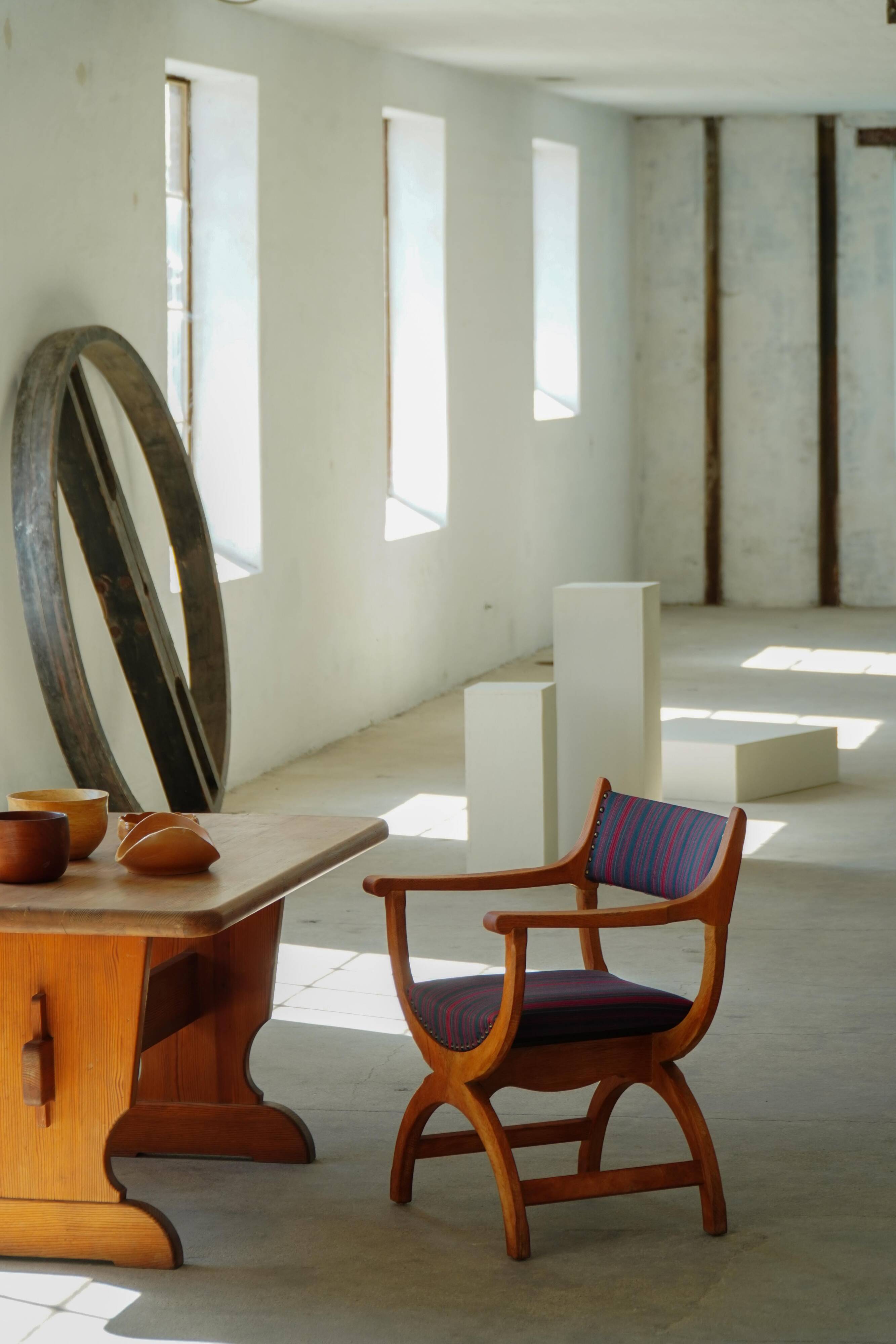 Henning Kjærnulf, pair of oak armchairs, model "Kurul", Danish modern style, 1960s.