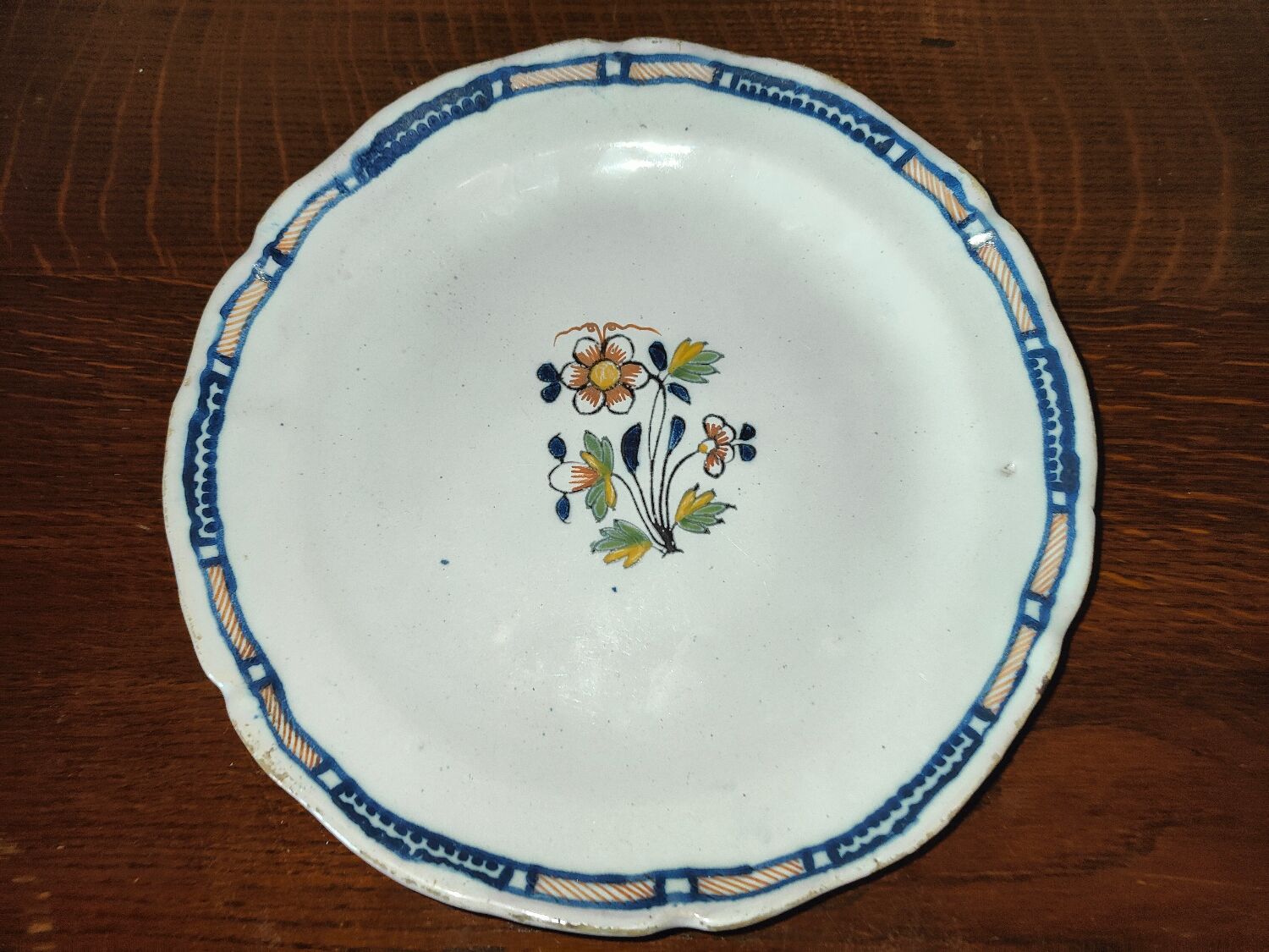Old earthenware plate of the North XVIIIth Century with floral decoration
