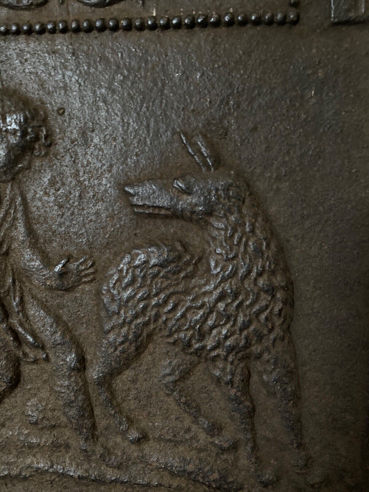 EIGHTEENTH CENTURY CAST IRON FIREPLACE PLATE REPRESENTING A WOMAN AND A WOLF
