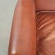 Cognac-coloured cow leather wingback armchair in English style