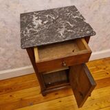 Antique wooden bedside table with black marble top