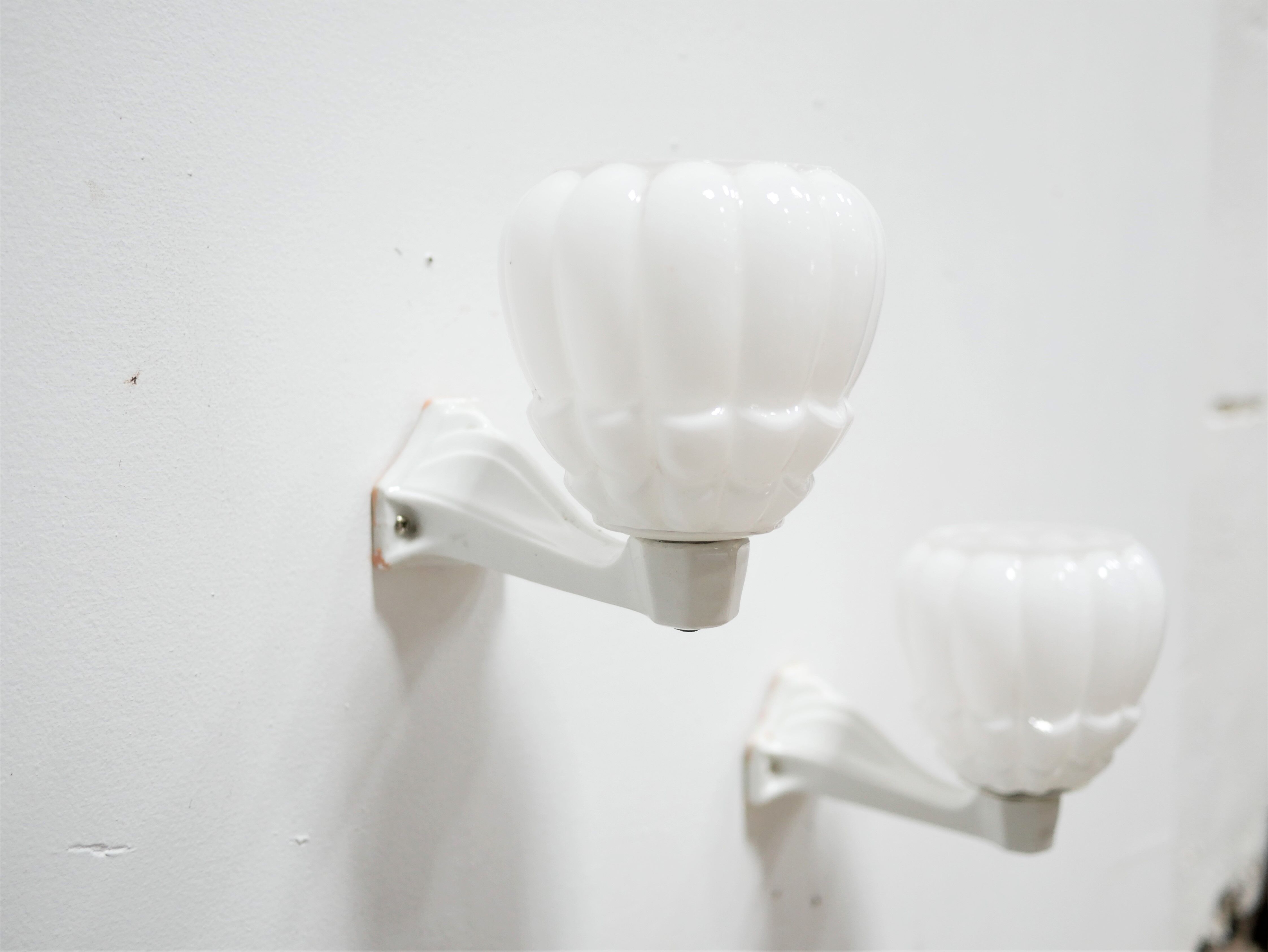 Pair of art deco porcelain and glass wall appliques