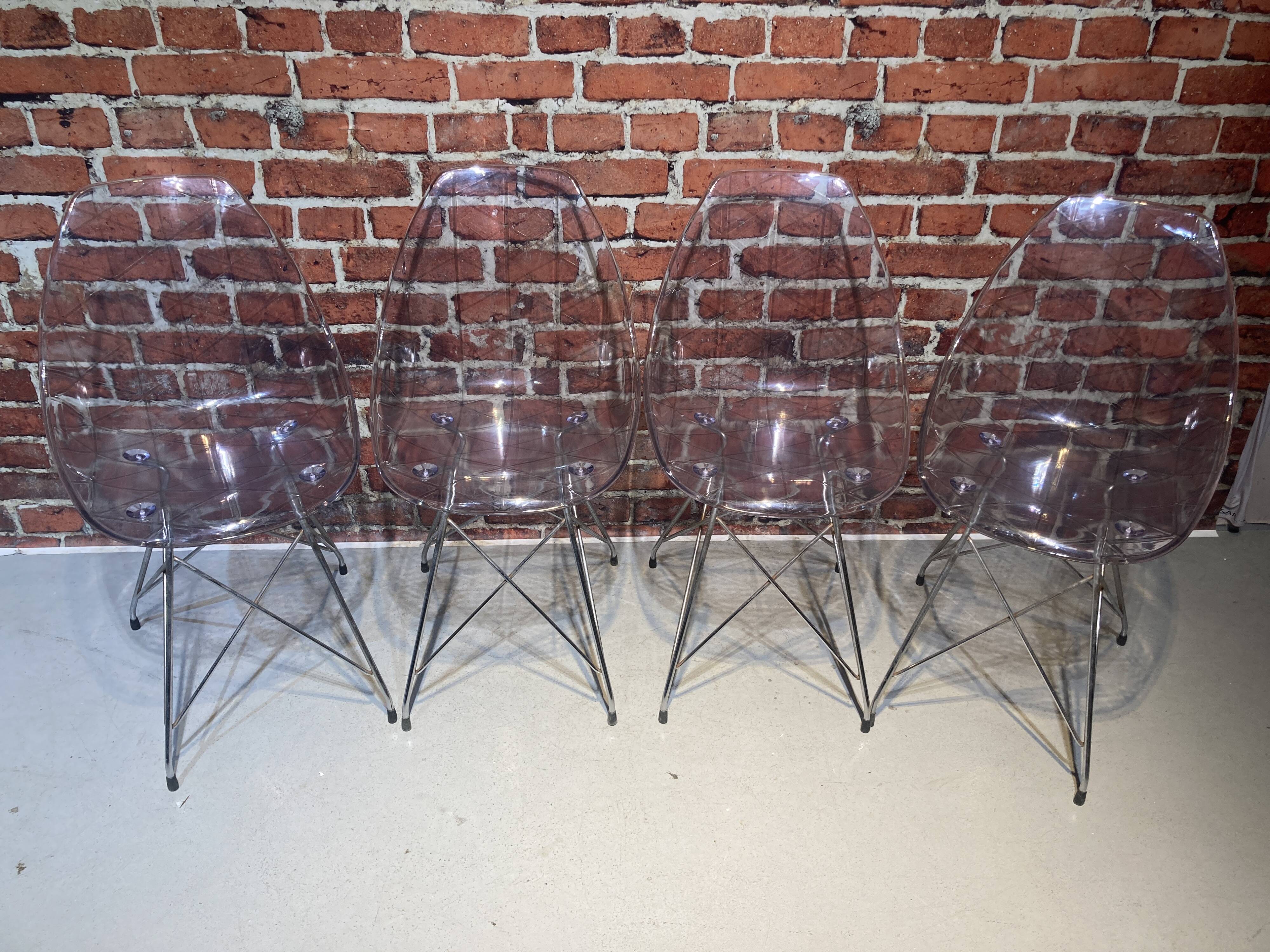 Set of four plexiglass and metal chairs