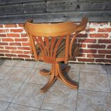 Vintage American swivel chair in wood and cane.