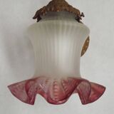 French Art Nouveau wall sconce in bronze with a white and pink glass shade.