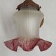 French Art Nouveau wall sconce in bronze with a white and pink glass shade.
