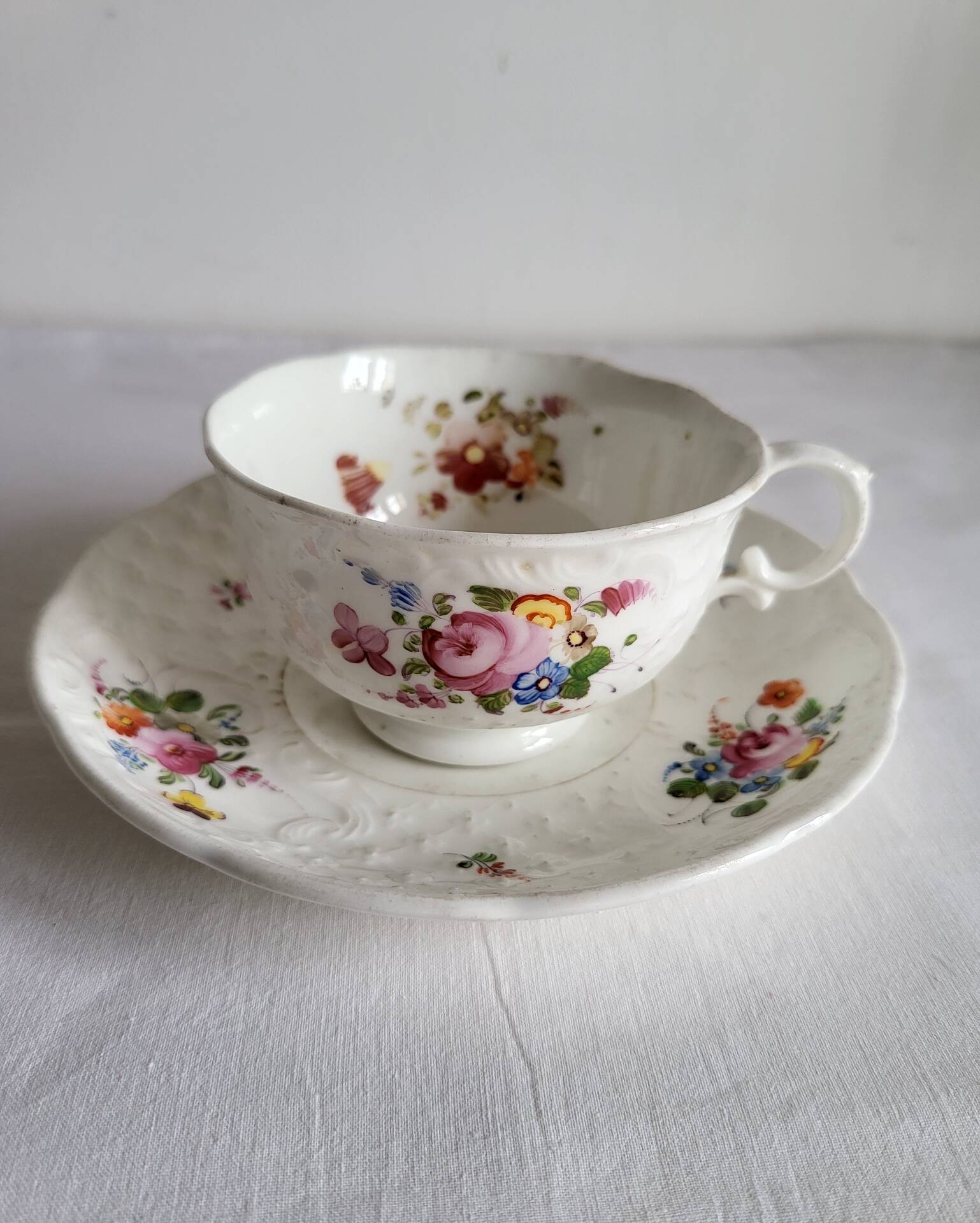 Antique Cup and Saucer in Porcelain with Hand-Painted Floral Decoration