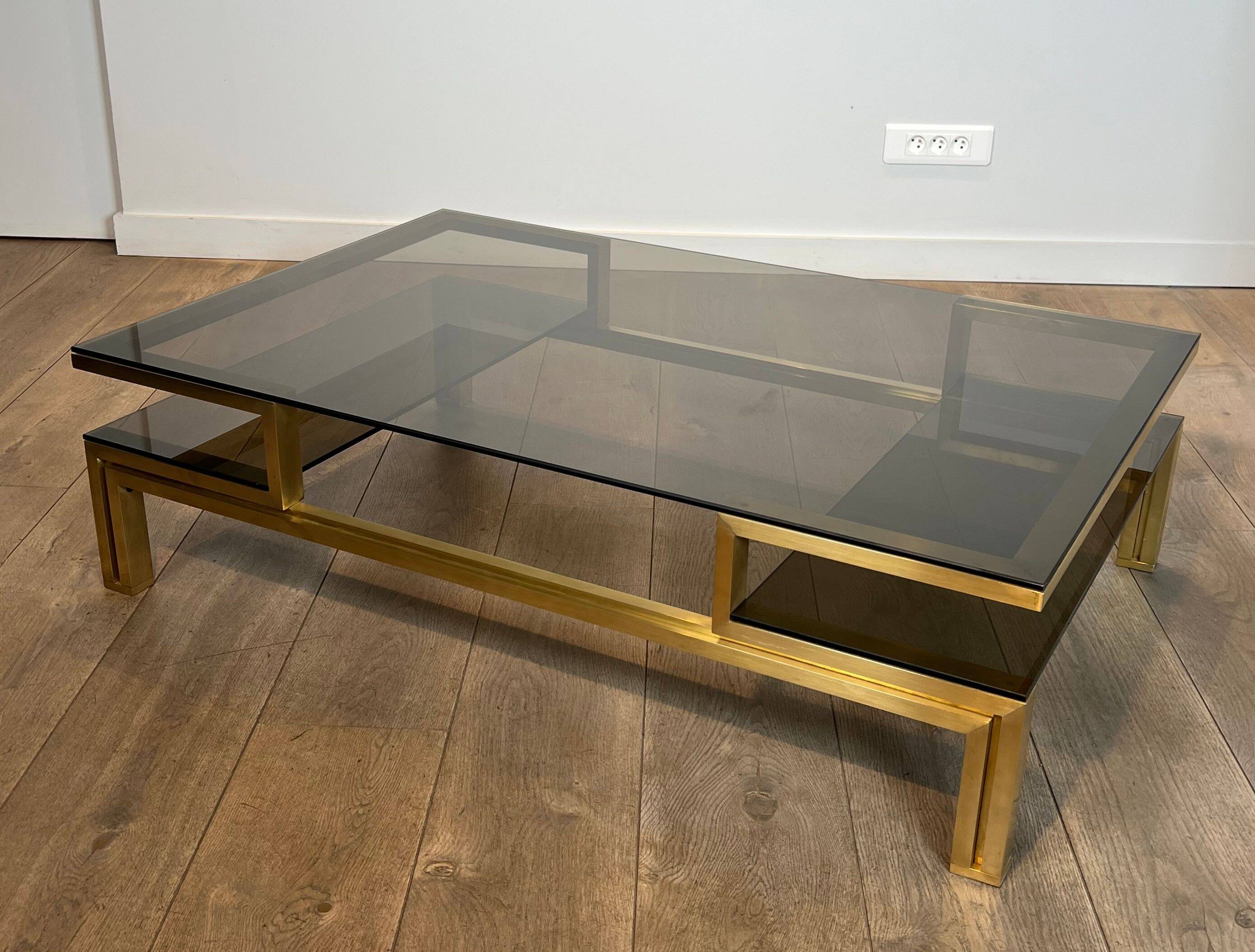 Modernist coffee table in brass and smoked glass tops by Guy Lefèvre for Maison Jansen.