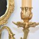 Pair of Louis XV style beveled mirror sconces in bronze by Lucien Gau