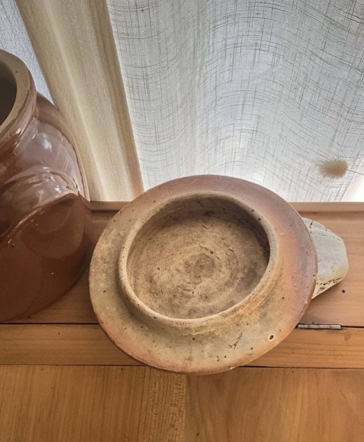 Ancient ceramic salt cellar and its lid.