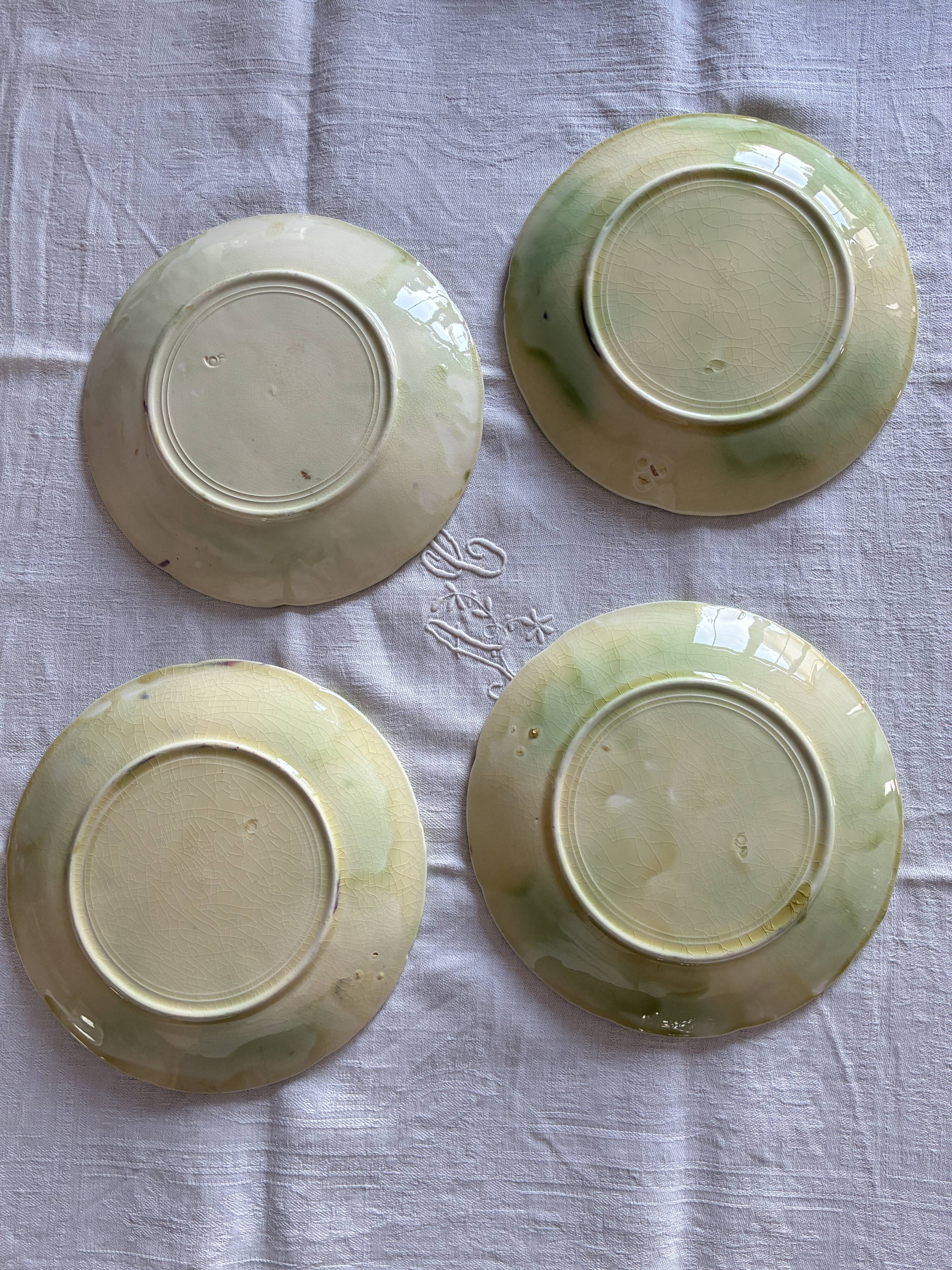 Lot of 4 Onnaing barbotine plates with grapevine design.