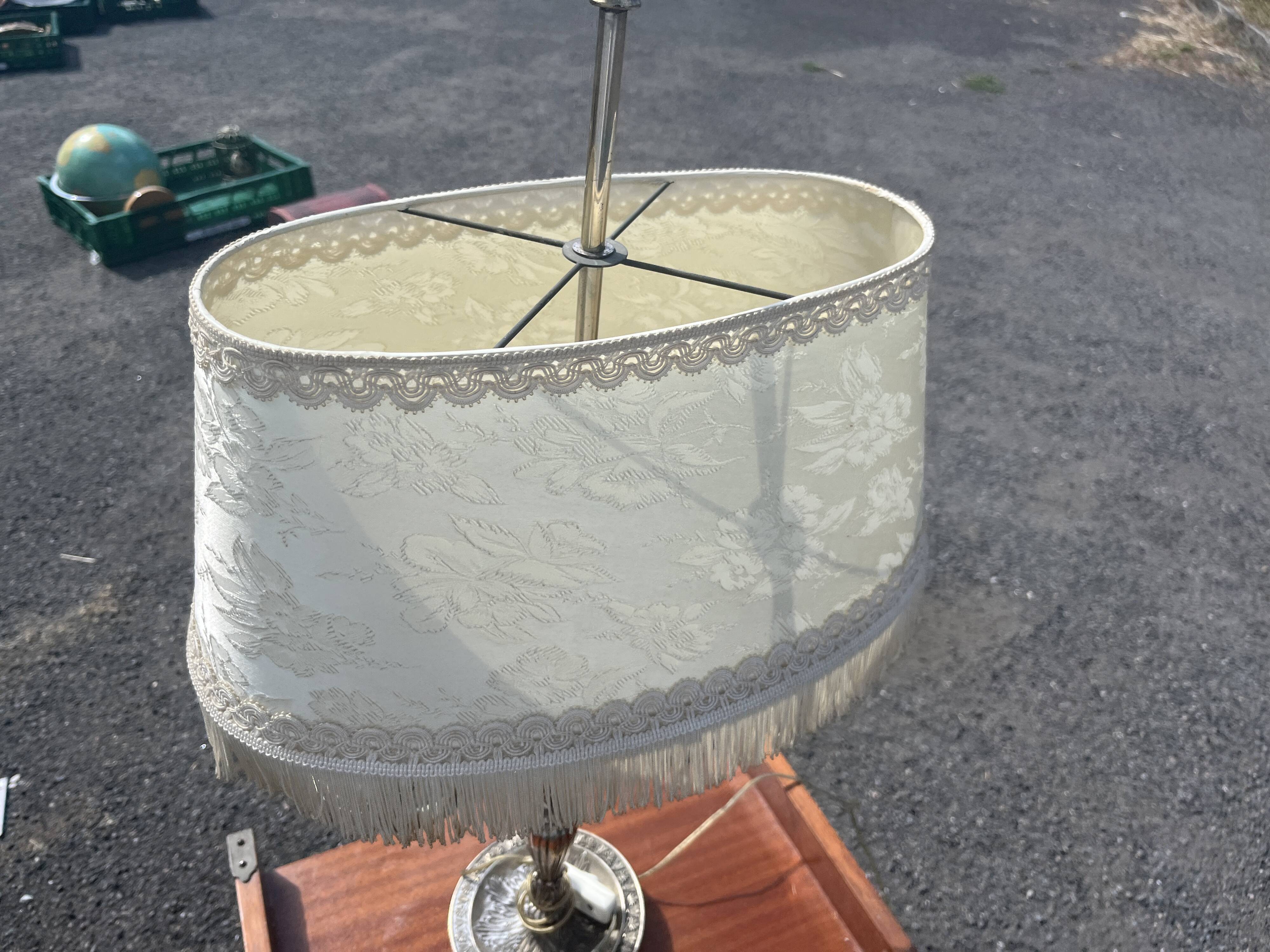 Two-armed hot water bottle lamp in silver metal with fringed fabric shade