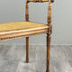 Banquette / tabouret en bois sculpté et cannage, XXe siècle