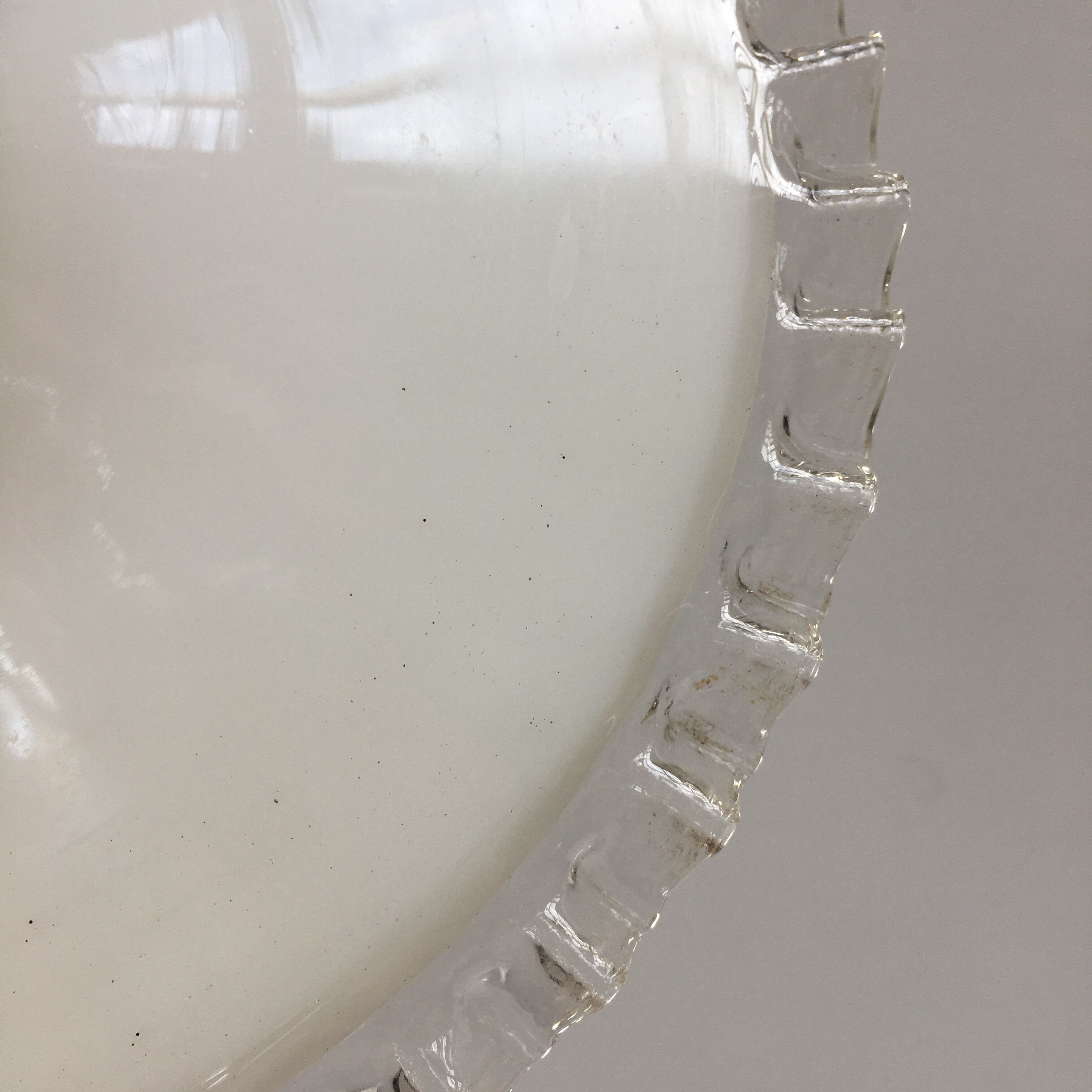Pair of white opaline suspensions with serrated edges