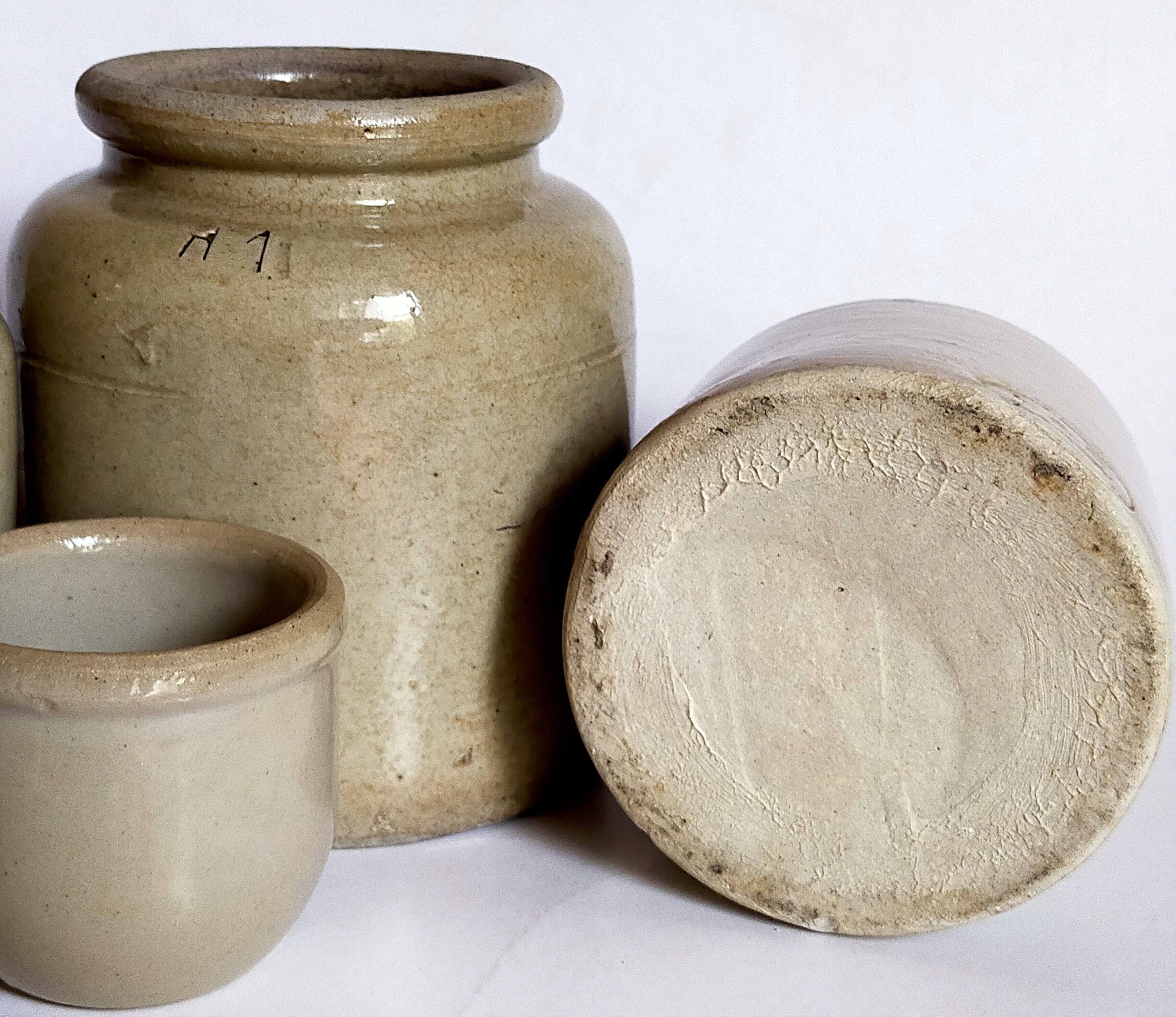 Set of three pots with old condiments in glazed earth