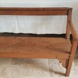 Church bench in fir tree with armrests