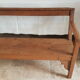 Church bench in fir tree with armrests