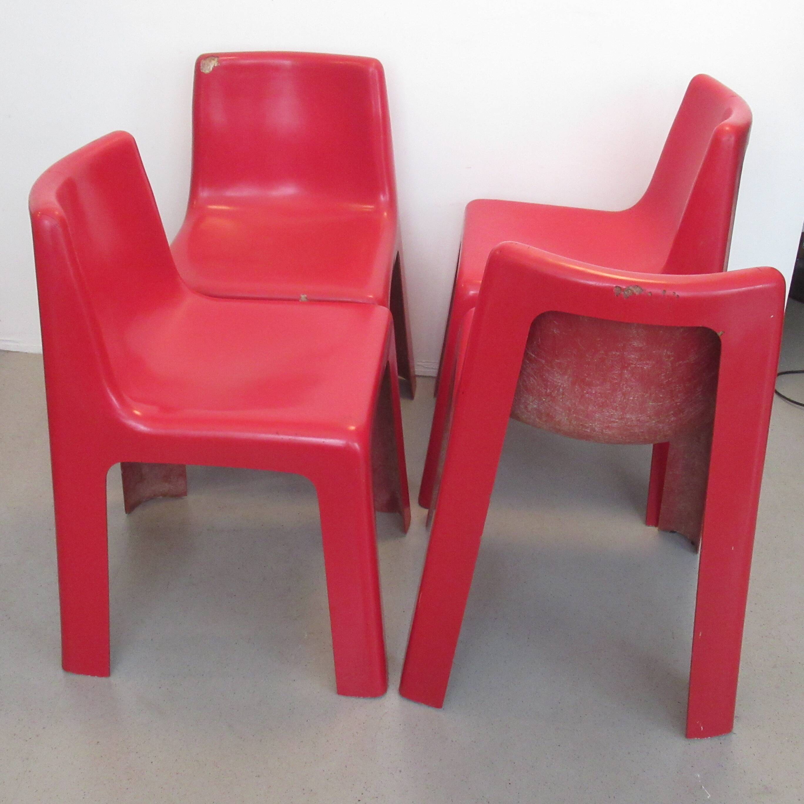 Four red fibreglass chairs from the 1970s.