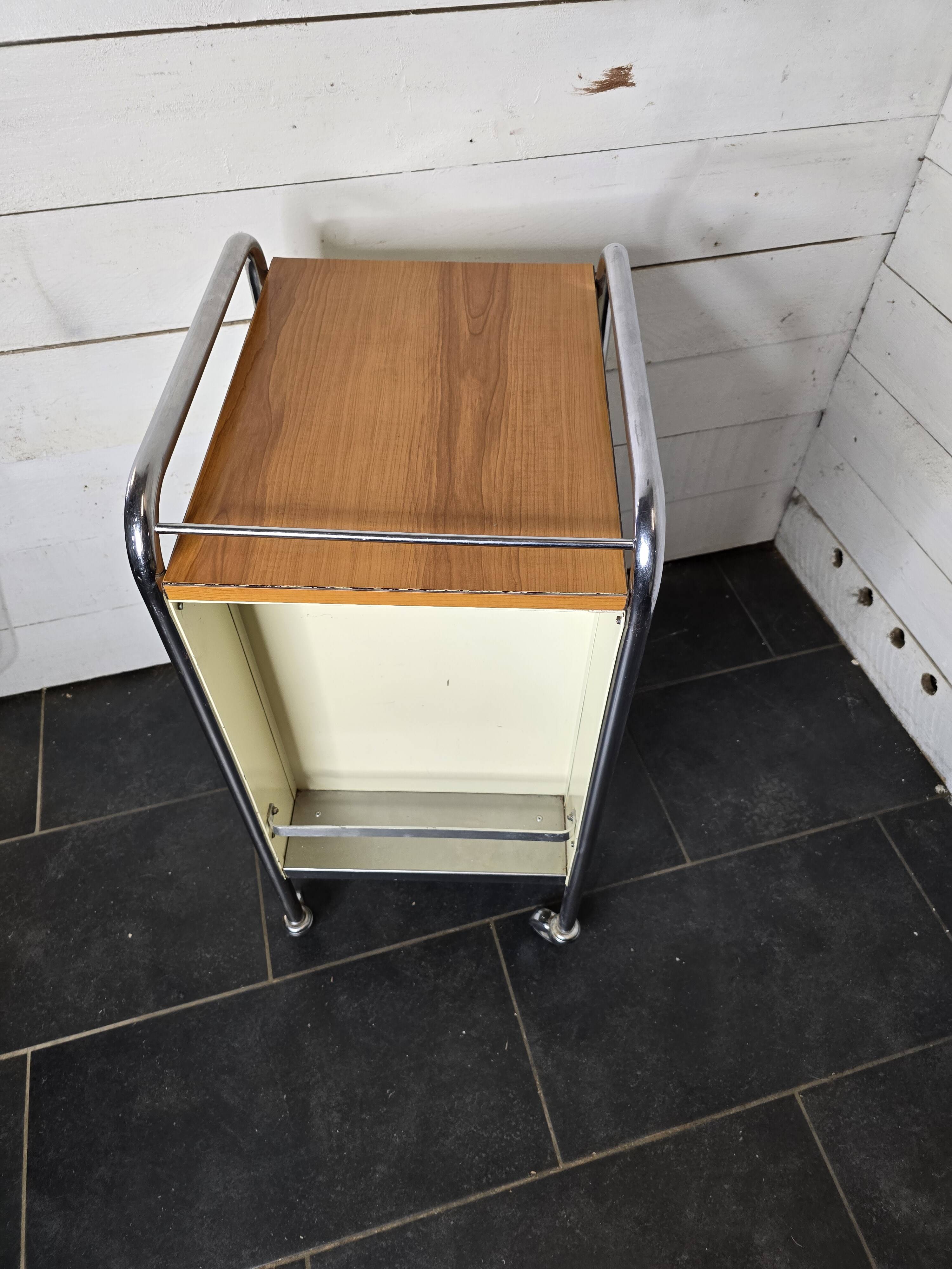 Mid-20th century metal cabinet table on wheels