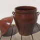 Large glazed terracotta jar, cognac colour with its lid.