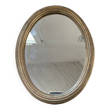 Classic oval mirror in gilded wood.