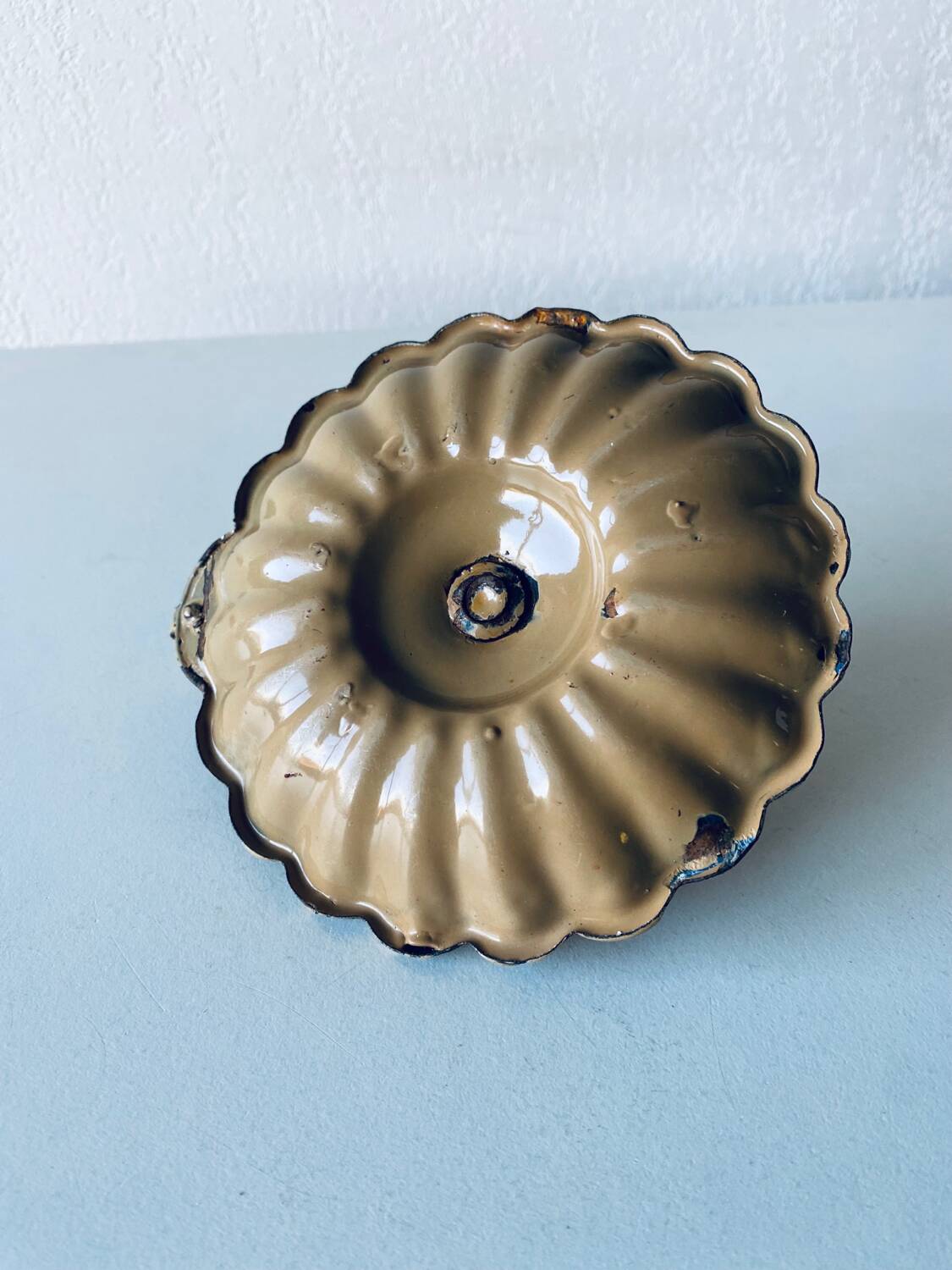Old candle holder in brown enameled metal