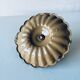 Old candle holder in brown enameled metal