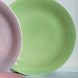 Seven pastel-colored plates mixed with vintage earthenware