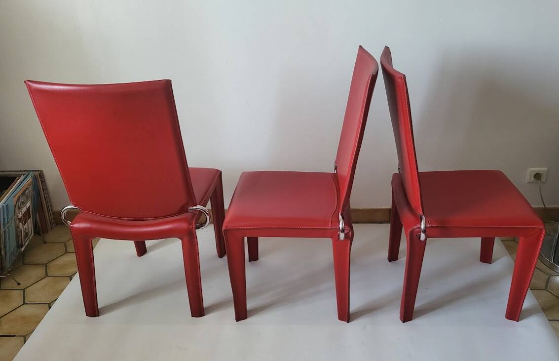 Red leather dining chairs by Arper
