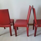 Red leather dining chairs by Arper