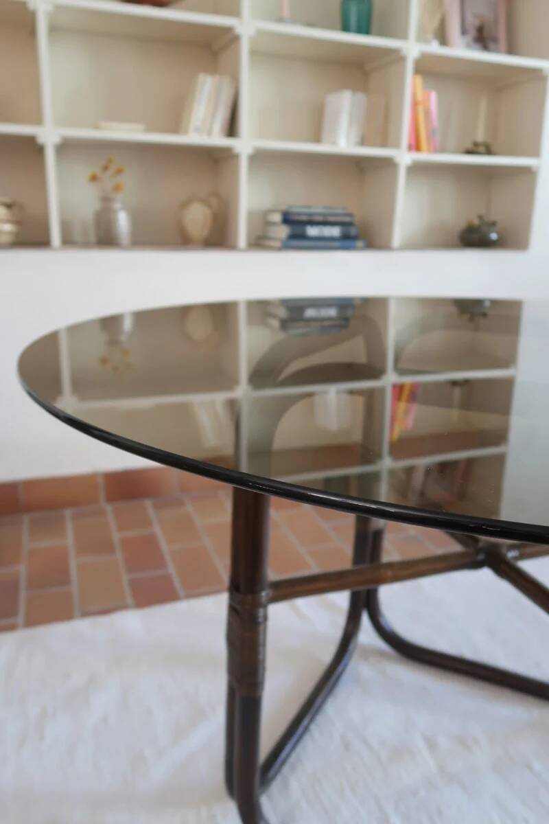 Round dining table in rattan, smoked glass top, 1970s.