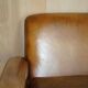 Three-seater Art Deco style leather sofa with feather cushions.
