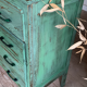 Vintage compass leg commode with a patina.