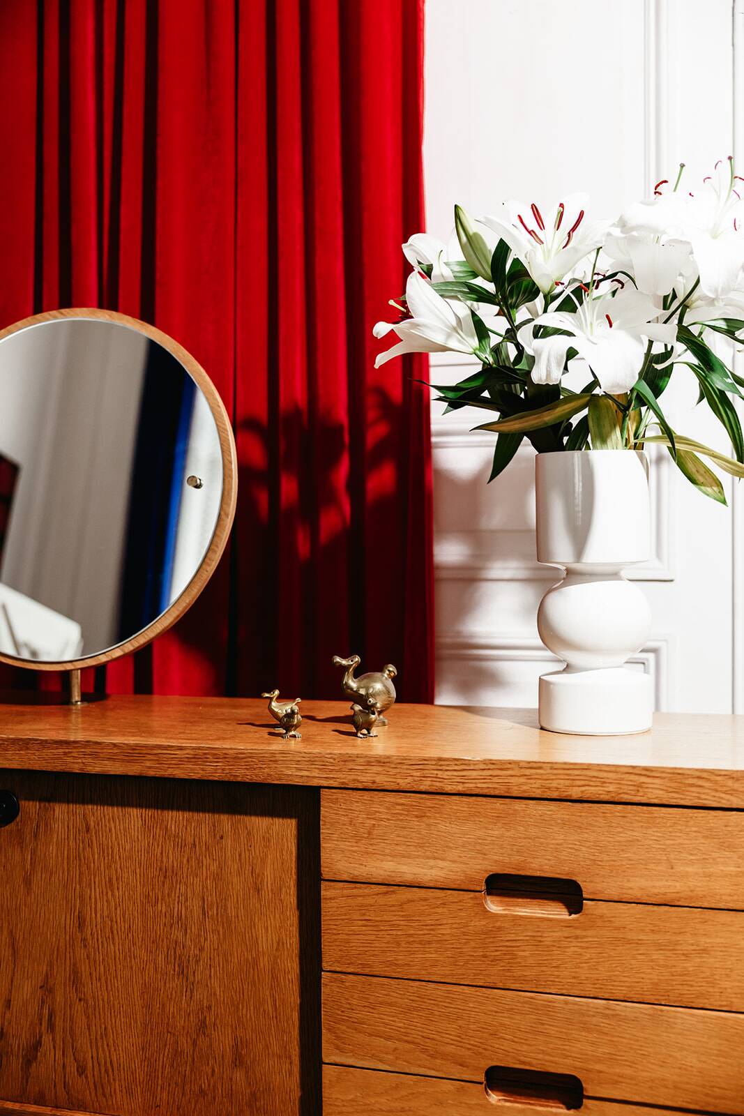 Vintage oak cabinet with circular mirror, 1960s modernist design.