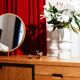 Vintage oak cabinet with circular mirror, 1960s modernist design.