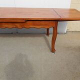 Large solid wood table with integrated extensions.