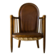 Antique armchair in solid wood and patinated brown leather, early 20th century.