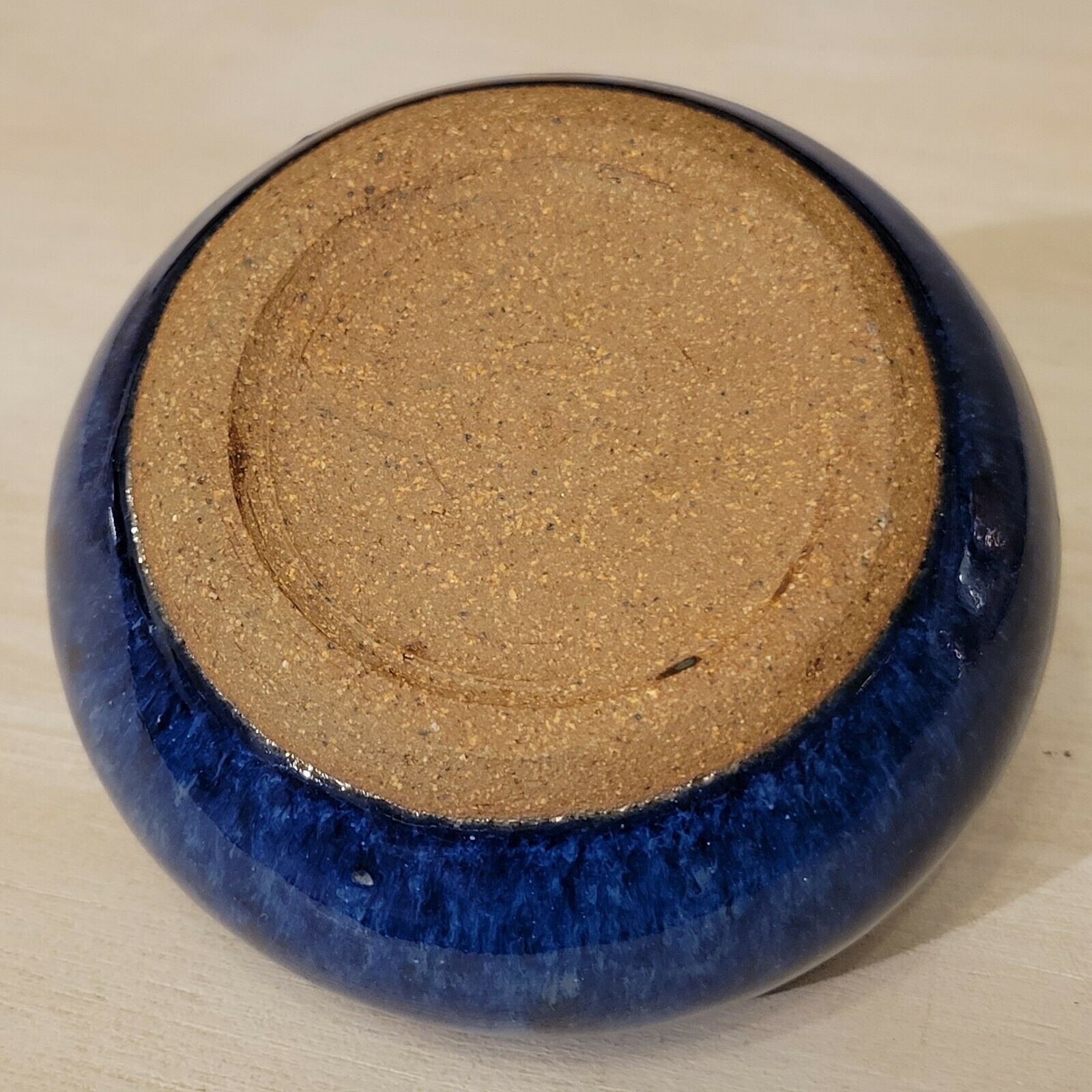 Small blue enamelled ceramic ball vase