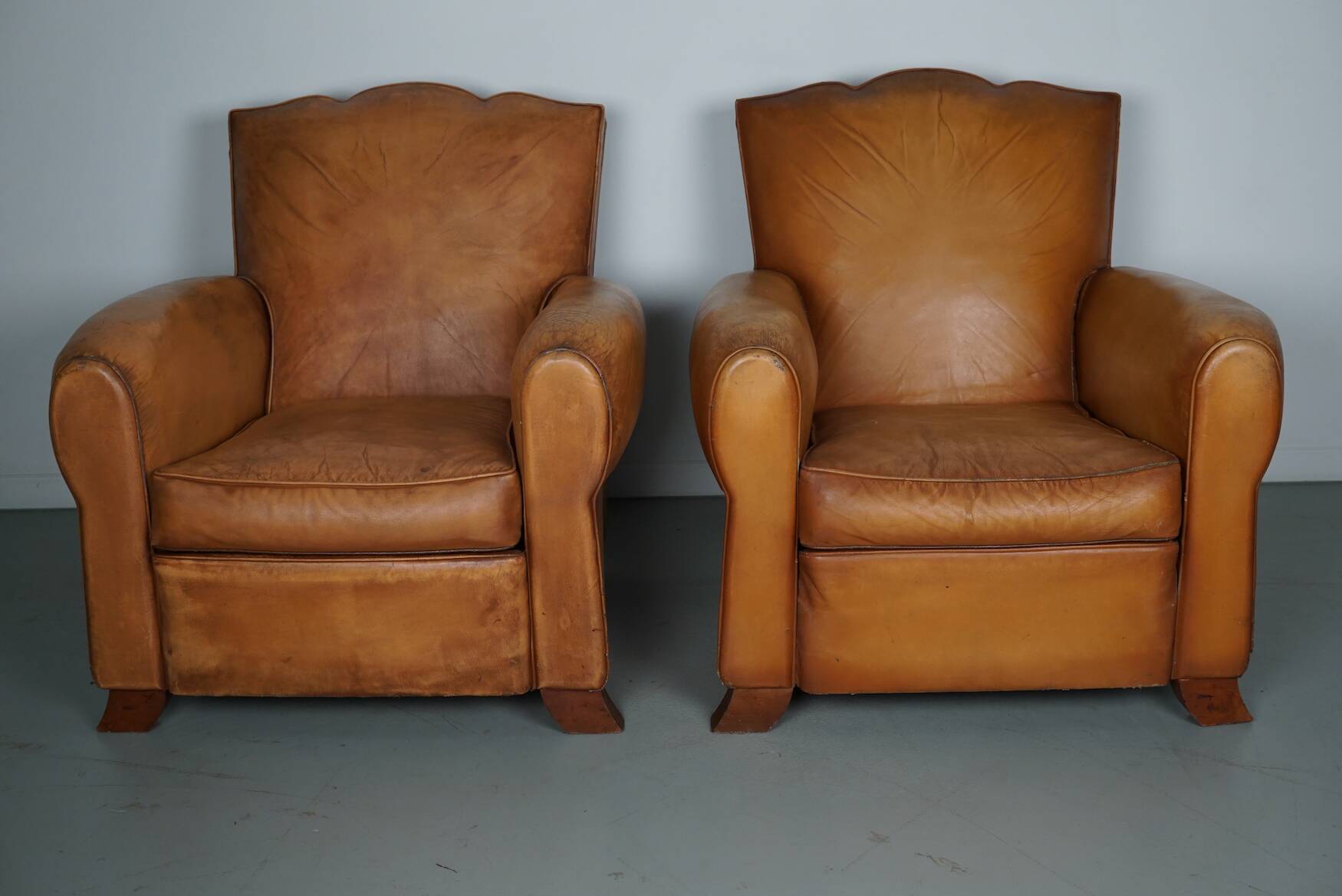 Pair of French Cognac Moustache Back Leather Club Chairs, 1950s