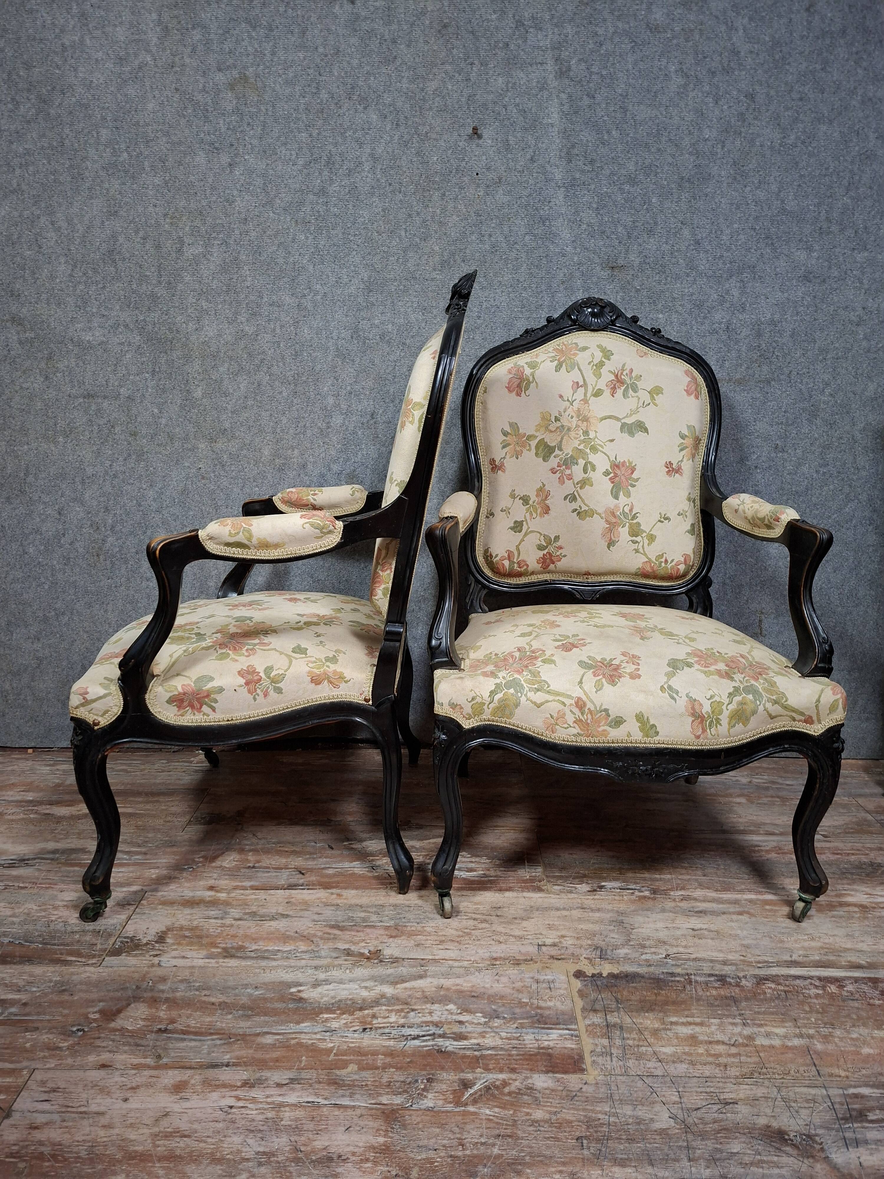 pair of Louis XV style armchairs, in moulded and carved wood, lacquered black