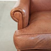 Light cognac-coloured English wingback armchair made of cowhide leather