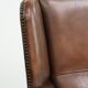 Subtle dark brown sheepskin wingback armchair with a timeless look subtle